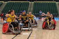Team Army and Team Navy athletes compete for the bronze medal in a wheelchair rugby match