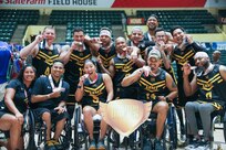 Team Army athletes pose for a photo with their medals after winning bronze in wheelchair rugby