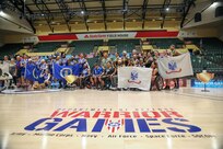 Warrior Games teams pose for a photo after the wheelchair rugby medal ceremony