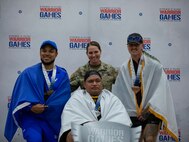 U.S. Army Sgt. 1st Class Jack Peko, center, wins a silver medal at the precision air event