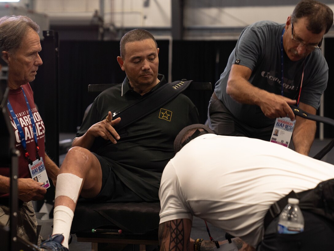 U.S. Army Cpt. Luis Avila prepares for indoor rowing familiarization