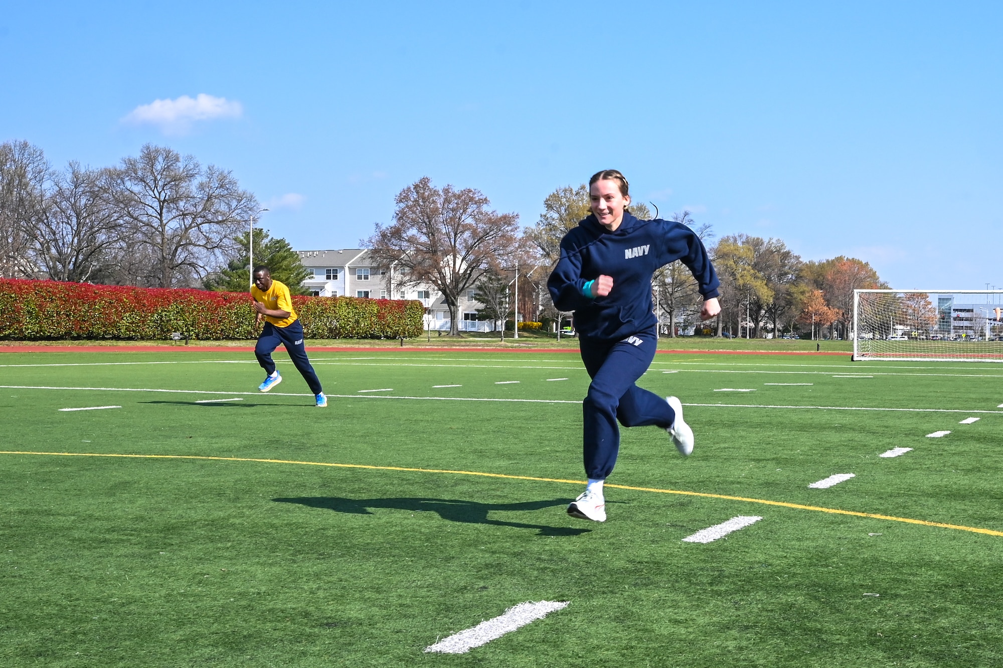 U.S. Navy Seaman Rachel Duff, Navy Ceremonial Guardsman, sprints during a running competition for the Sexual Assault Prevention and Response Olympics event on Joint Base Anacostia-Bolling, Washinton, D.C., March 29, 2024. The competition consisted of tug-of-war, foot racing, egg carrying, sack racing and beer goggle racing. (U.S. Air Force photo by Airman Shanel Toussaint)