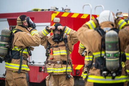 Firefighters donning gear