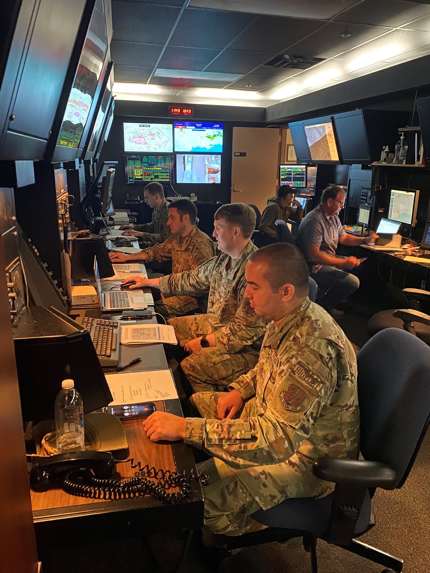 Airmen looking at computer screens