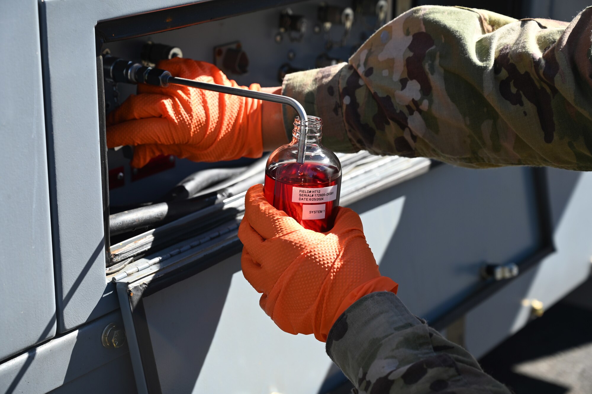 U.S. Air Force Staff Sgt. Erica Buckland, an aerospace ground equipment craftsman with the 62d Maintenance Squadron, removes hydraulic fluid from a universal hydraulic test stand at Joint Base Lewis-McChord, Washington, June 25, 2024. A universal hydraulic test stand is used for testing and troubleshooting hydraulic systems and components of the aircraft. AGE Airmen conduct routine maintenance on equipment to ensure all systems work appropriately before sending them to the flightline. (U.S. Air Force photo by Airman 1st Class Kylee Tyus)