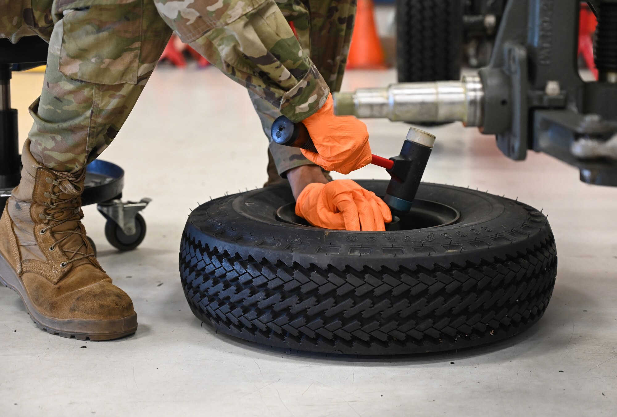 U.S. Air Force Airman 1st Class Ryan Ellison, an aerospace ground equipment journeyman with the 62d Maintenance Squadron, replaces a seal on a nose landing gear trailer tire at Joint Base Lewis-McChord, Washington, June 25, 2024. By sealing the tires on the trailer, AGE Airmen ensure the stability and maneuverability of the nose landing gear trailer, contributing to the overall safety during aircraft maintenance tasks. (U.S. Air Force photo by Airman 1st Class Kylee Tyus)
