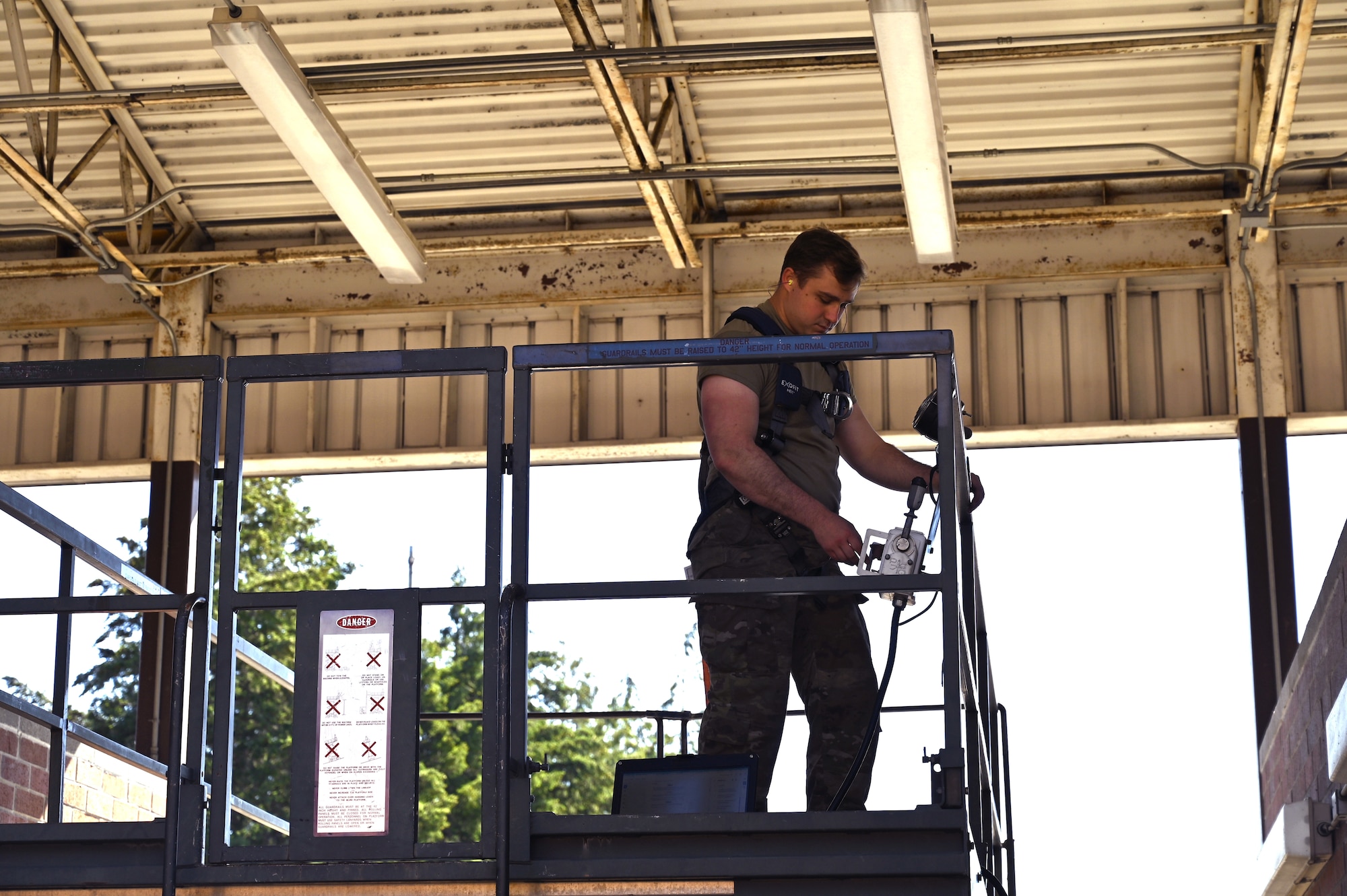 U.S. Air Force Staff Sgt. Quincy Osterlund, an aerospace ground equipment journeyman with the 62d Aircraft Maintenance Squadron, performs a routine inspection on a split deck at Joint Base Lewis-McChord, Washington, June 25, 2024. AGE Airmen conduct routine maintenance on equipment to ensure all systems work appropriately before sending them to the flightline. (U.S. Air Force photo by Airman 1st Class Kylee Tyus)