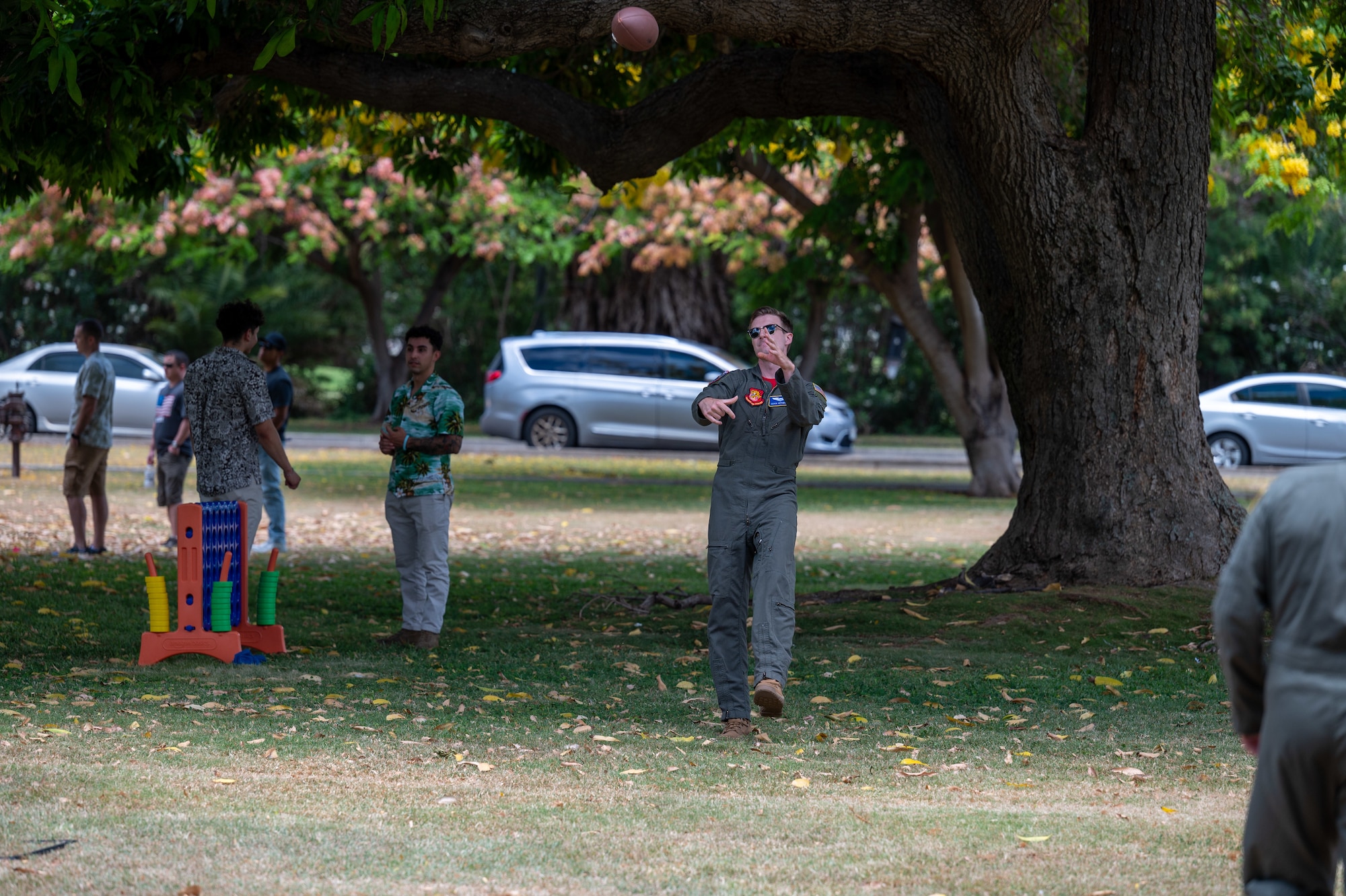 Airmen throw a football.