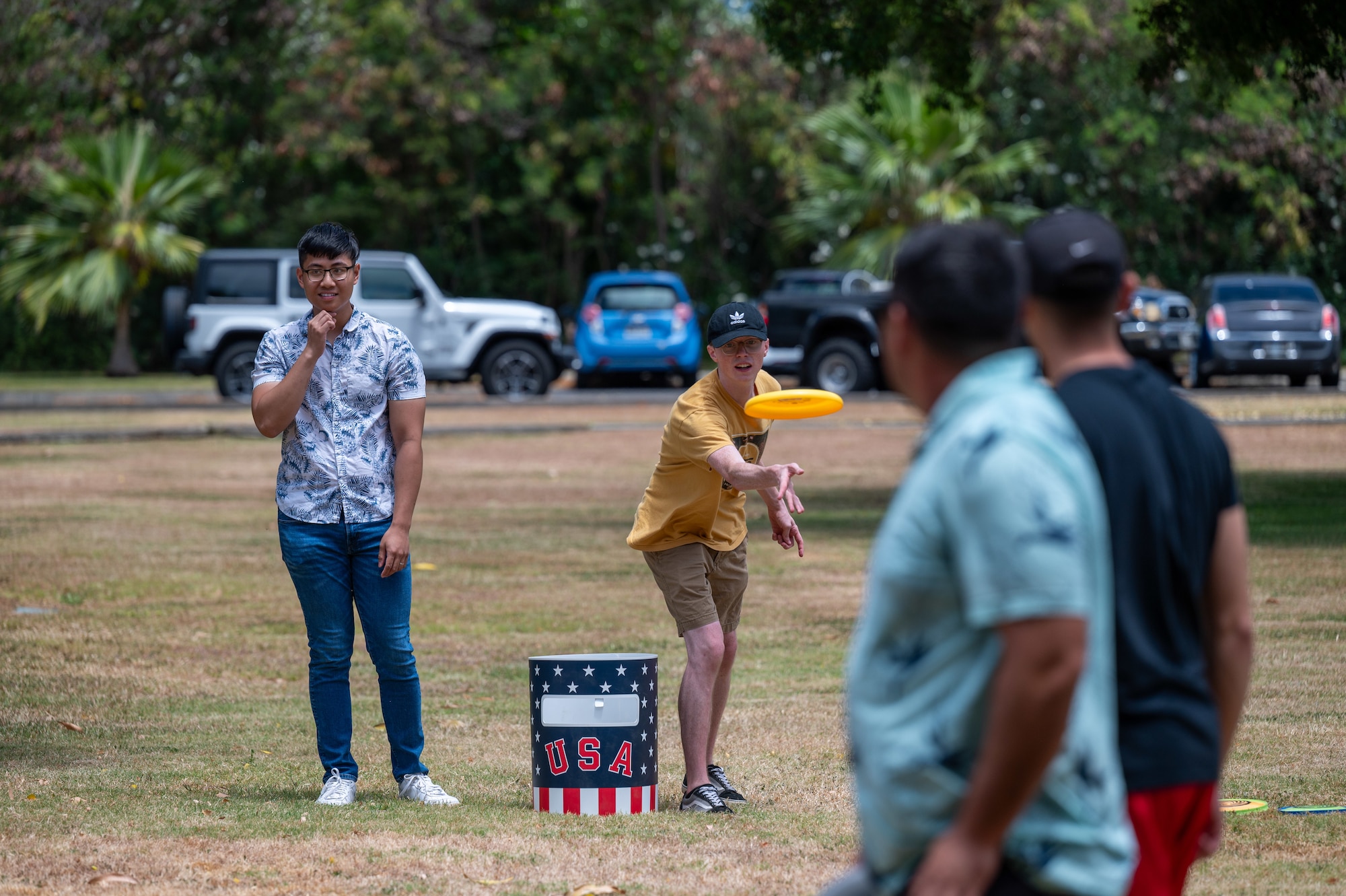 Airmen throw frisbee.