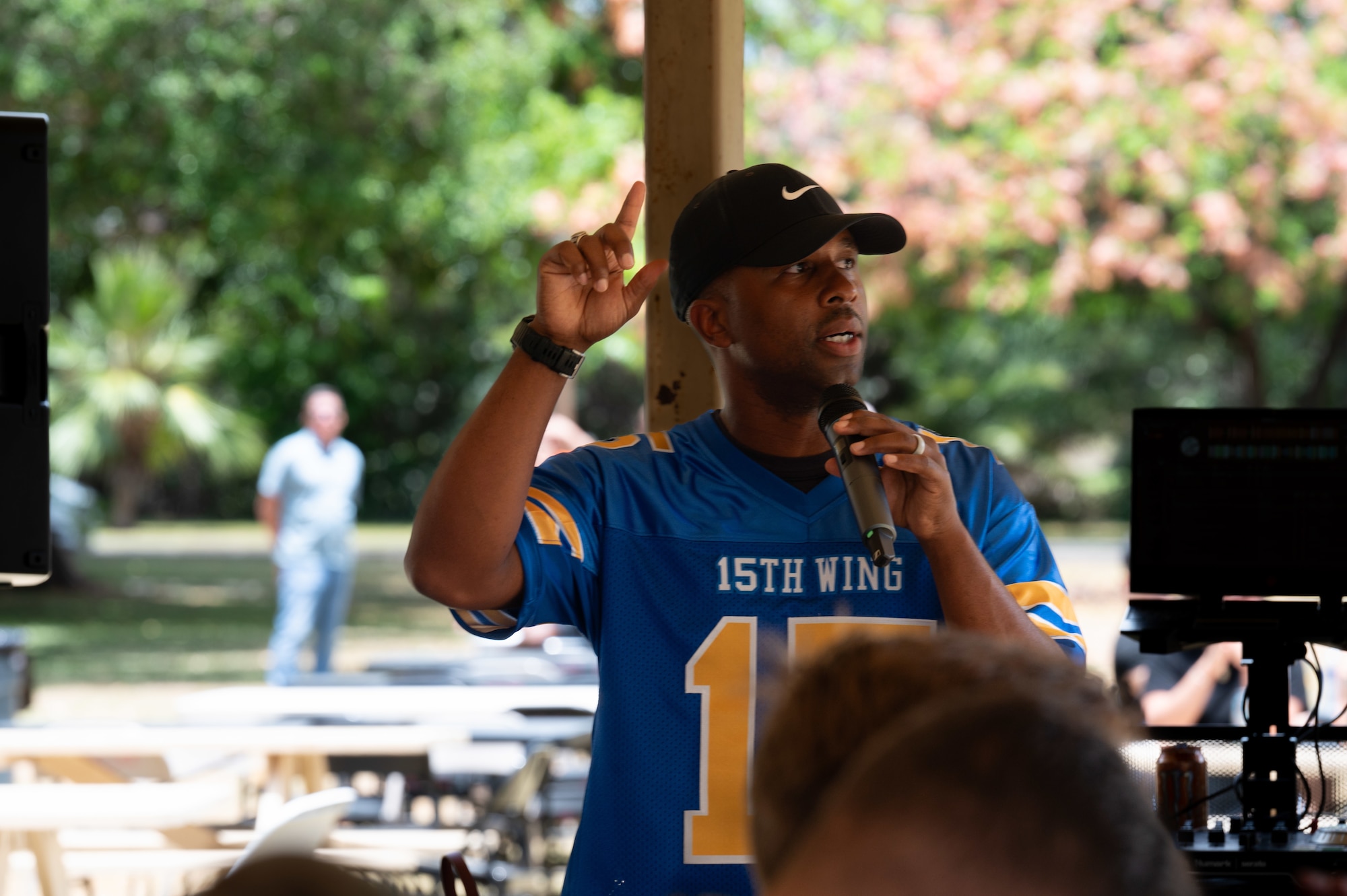 Airman speaks with a microphone.