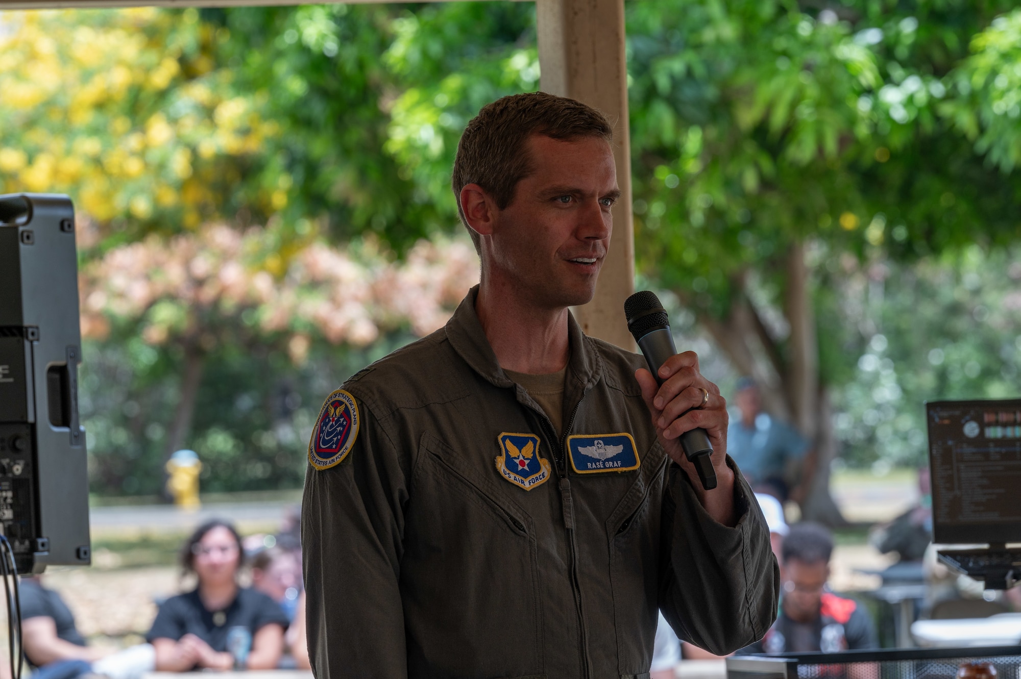 Airman speaks with a microphone.