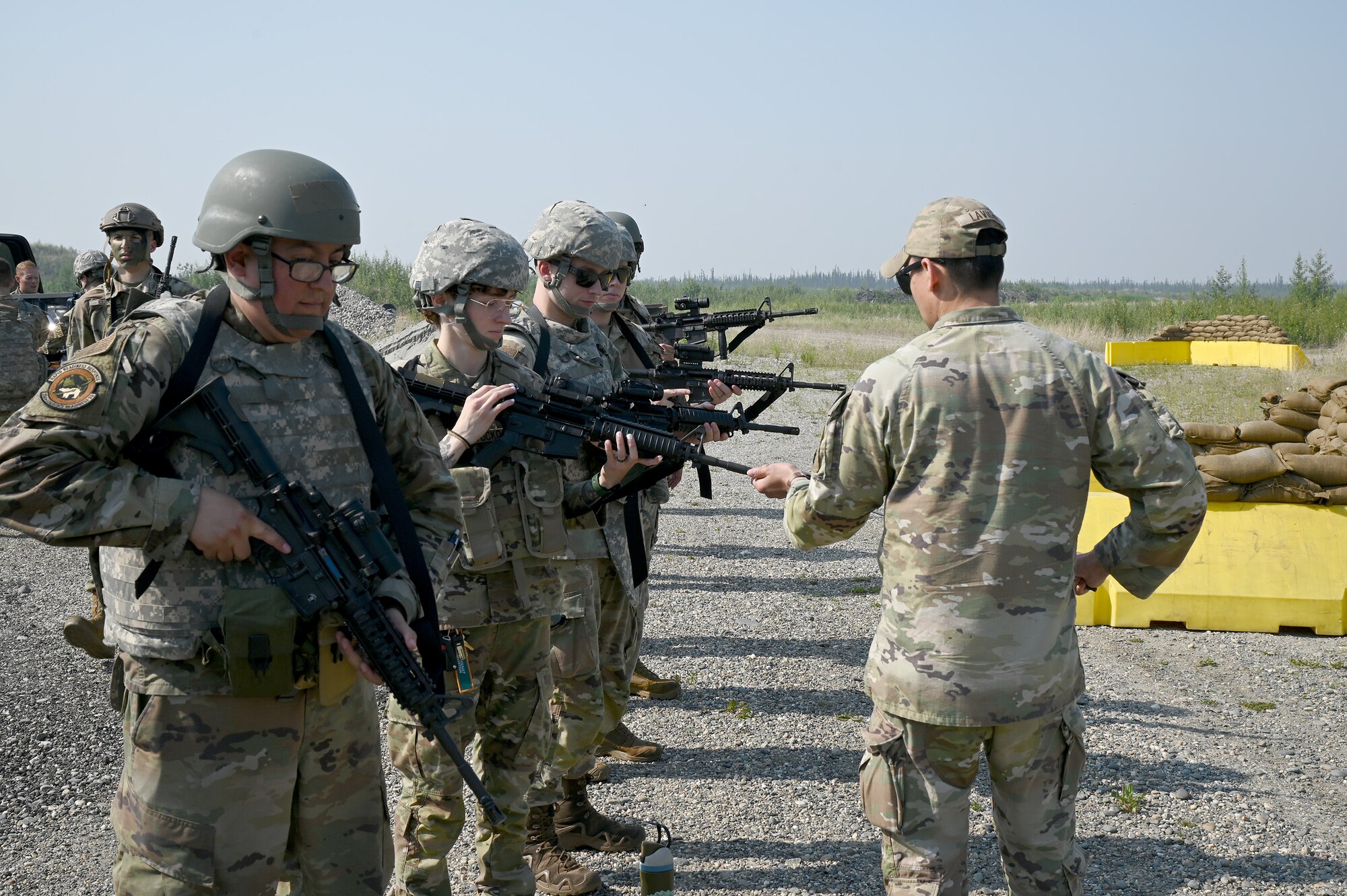 Airmen from the 354th Fighter Wing line up to clear barrels during the Advanced Ready Training-Core (ART-C) Course June 26, 2024 at Eielson Air Force Base.