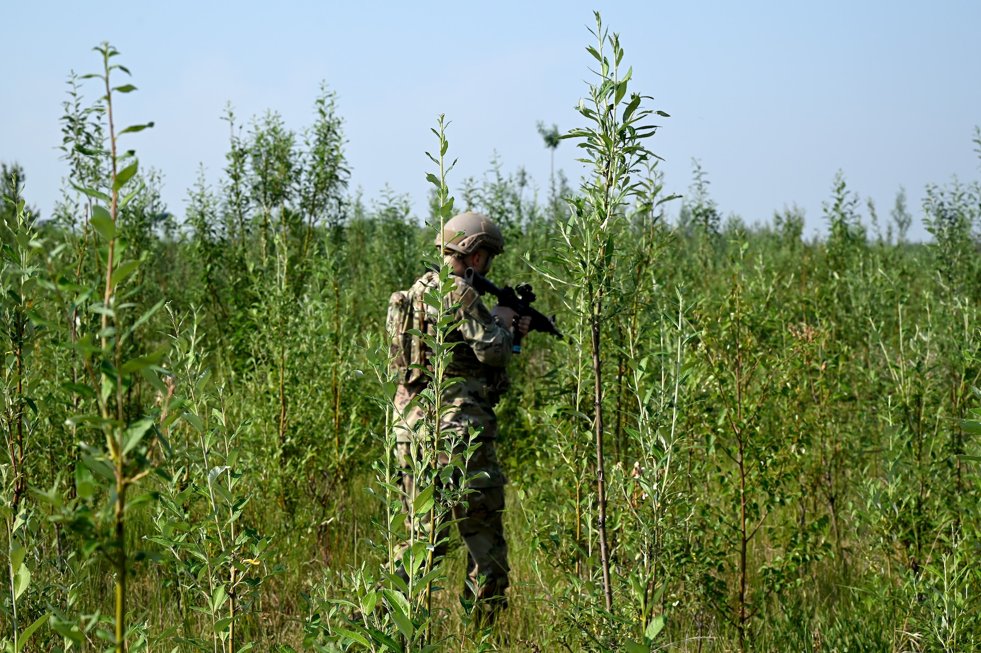 An Airmen from the 354th Fighter Wing conducts a squad maneuver during the Advanced Ready Training-Core Course June 26, 2024 at Eielson Air Force Base.