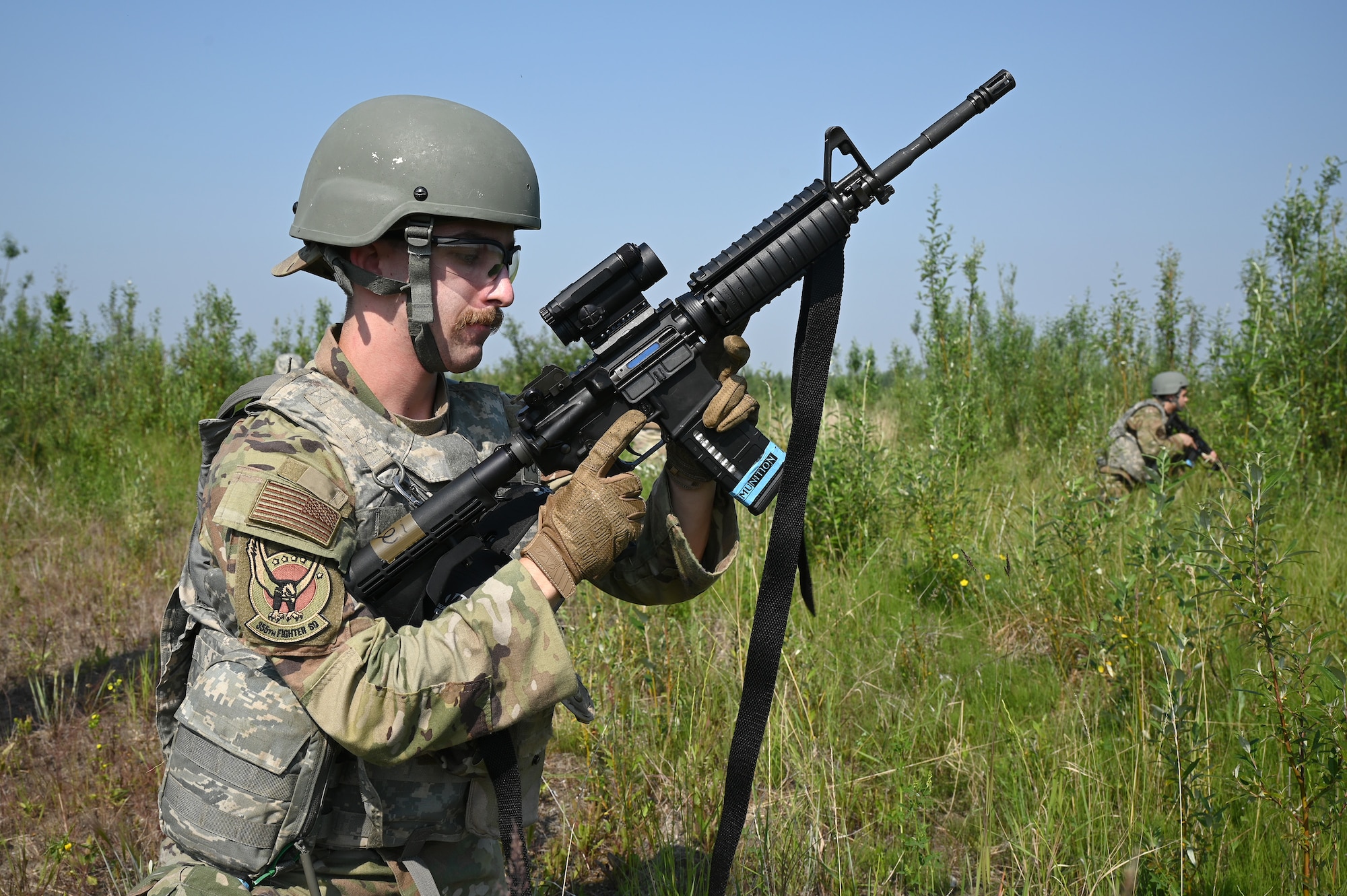 An Airmen from the 355th Aircraft Maintenance reloads his M4 during the Advanced Ready Training-Core Course June 26, 2024 at Eielson Air Force Base.