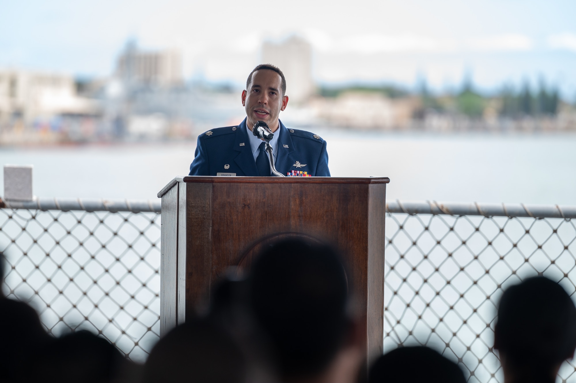Airman speaks at a podium.