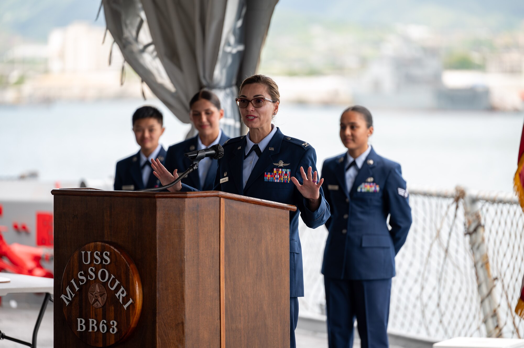 Airman speaks at a podium.