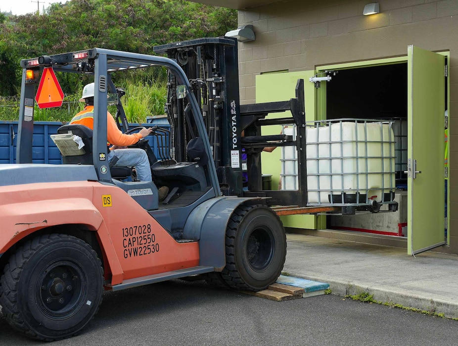 HALAWA, Hawaii (June 24, 2024) A Naval Facilities Engineering Systems Command (NAVFAC) Hawaii Rigger, in support of Navy Closure Task Force-Red Hill (NCTF-RH), uses a forklift to move an aqueous film-forming foam (AFFF) tote to a truck for transport from the Red Hill Bulk Fuel Storage Facility (RHBFSF) in Halawa, Hawaii, June 24, 2024. Three 265-gallon totes of 3% AFFF concentrate were transferred to Military Sealift Command for usage onboard ships in the fleet. Charged with the safe decommissioning of the RHBFSF, NCTF-RH was established by the Department of the Navy as a commitment to the community and the environment. (U.S. Navy photo by Mass Communication Specialist 1st Class Glenn Slaughter)