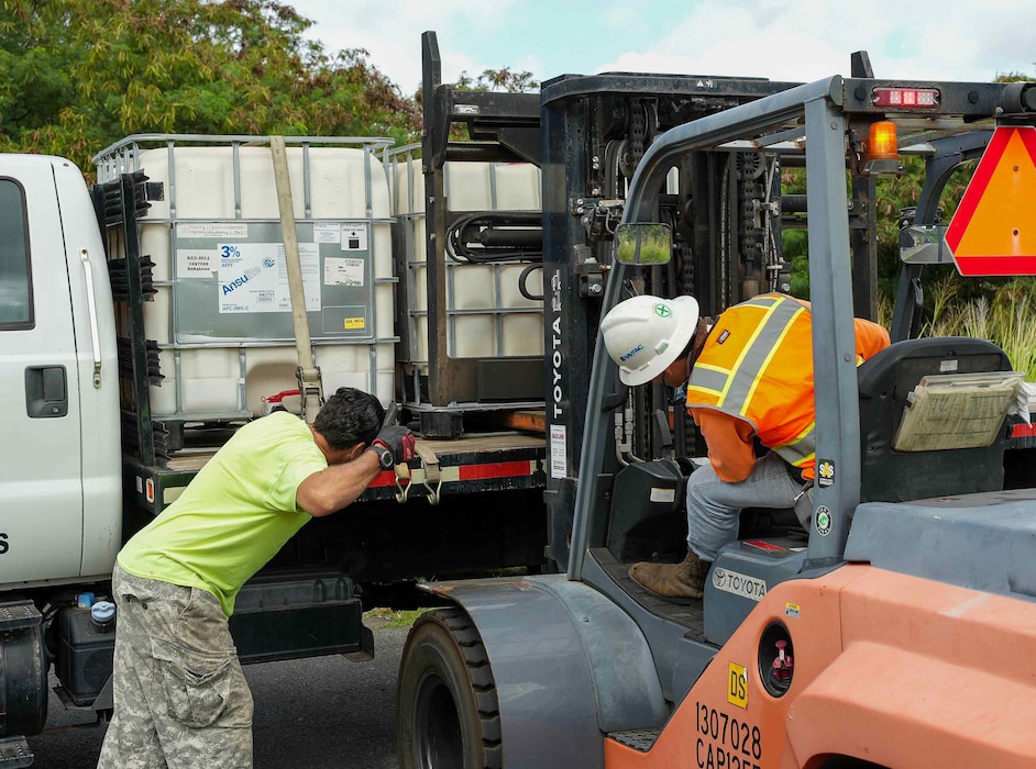 HALAWA, Hawaii (June 24, 2024) Naval Facilities Engineering Systems Command (NAVFAC) Hawaii personnel, in support of Navy Closure Task Force-Red Hill (NCTF-RH), use a forklift to load an aqueous film-forming foam (AFFF) tote onto a truck for transport from the Red Hill Bulk Fuel Storage Facility (RHBFSF) in Halawa, Hawaii, June 24, 2024. Three 265-gallon totes of 3% AFFF concentrate were transferred to Military Sealift Command for usage onboard ships in the fleet. Charged with the safe decommissioning of the RHBFSF, NCTF-RH was established by the Department of the Navy as a commitment to the community and the environment. (U.S. Navy photo by Mass Communication Specialist 1st Class Glenn Slaughter)