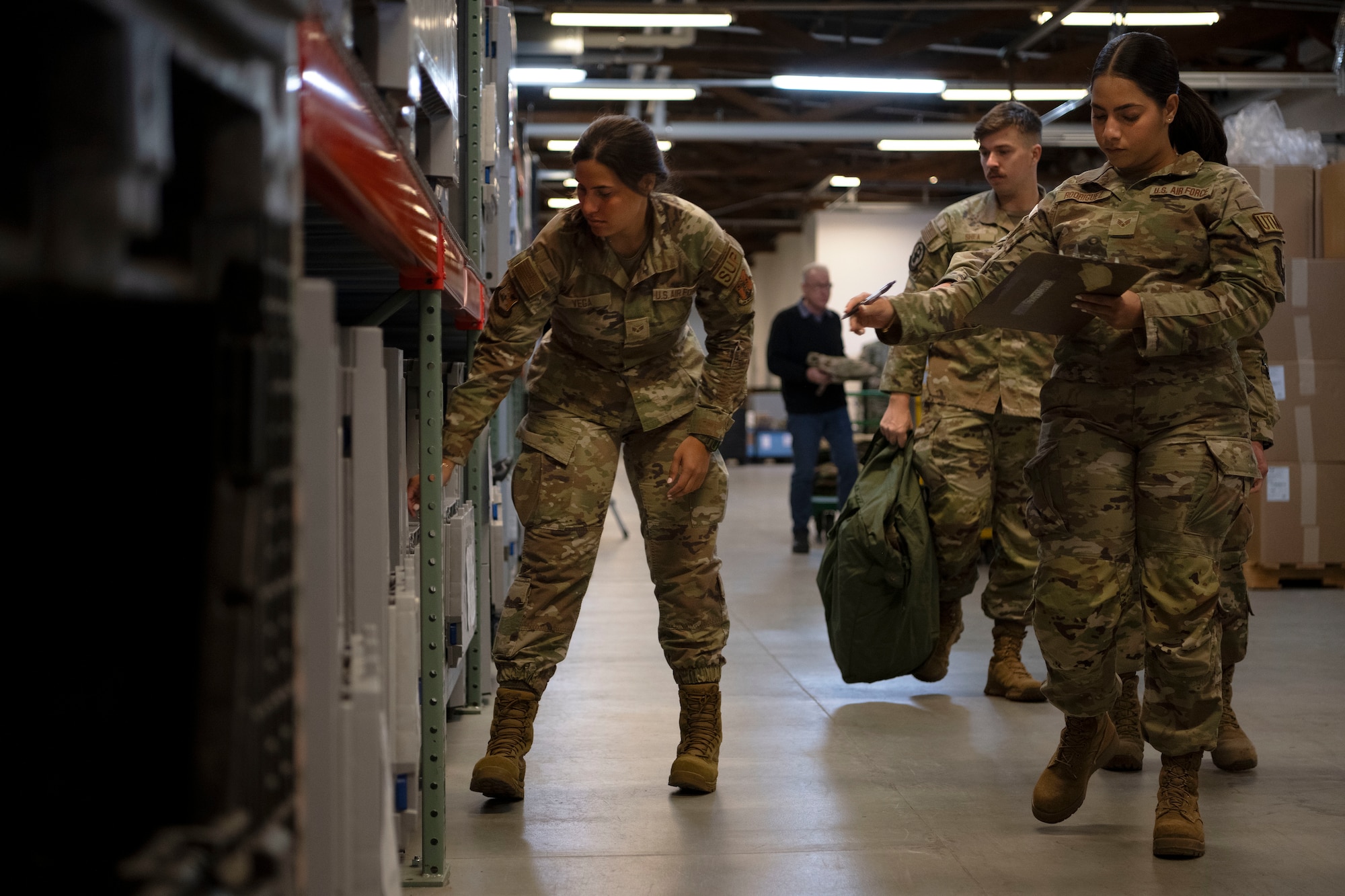 From left, U.S. Air Force Senior Airman Alondra Vega, a material management journeyman and Senior Airman Stephanie Rodriguez, a material management journeyman, both assigned to the 156th Logistics Readiness Squadron, Puerto Rico Air National Guard, retrieve mission oriented protective posture training gear to issue during the Saber Knight Readiness exercise at Spangdahlem Air Base, Germany, May 6, 2024. Saber Knight Readiness Exercise 24-01 incorporated lessons learned from previous exercises and tested the 52nd Fighter Wing’s ability to rapidly generate F-16 Fighting Falcon sorties; execute base defense operations during simulated threats including chemical, biological, radiological, and nuclear (CBRN) attacks; and further develop and execute command, control, and communication (C3) tactics in support of contingency and war-time operations. (U.S. Air National Guard photo by Master Sgt. Rafael D. Rosa)
