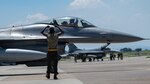 U.S. Air Force Capt. Brian Stueckle, 80th Fighter Squadron F-16 pilot, and Airman 1st Class Zakkee Conwell, 80th Fighter Generation Squadron crew chief, give the Juvats 'Crush Em' gesture during Buddy Squadron 24-4 at Cheongju Air Base, Republic of Korea, June 26, 2024. Pilots integrated with ROK Air Force pilots to develop new tactics and techniques to better defend the peninsula. (U.S. Air Force photo by Staff Sgt. Nicholas Ross)