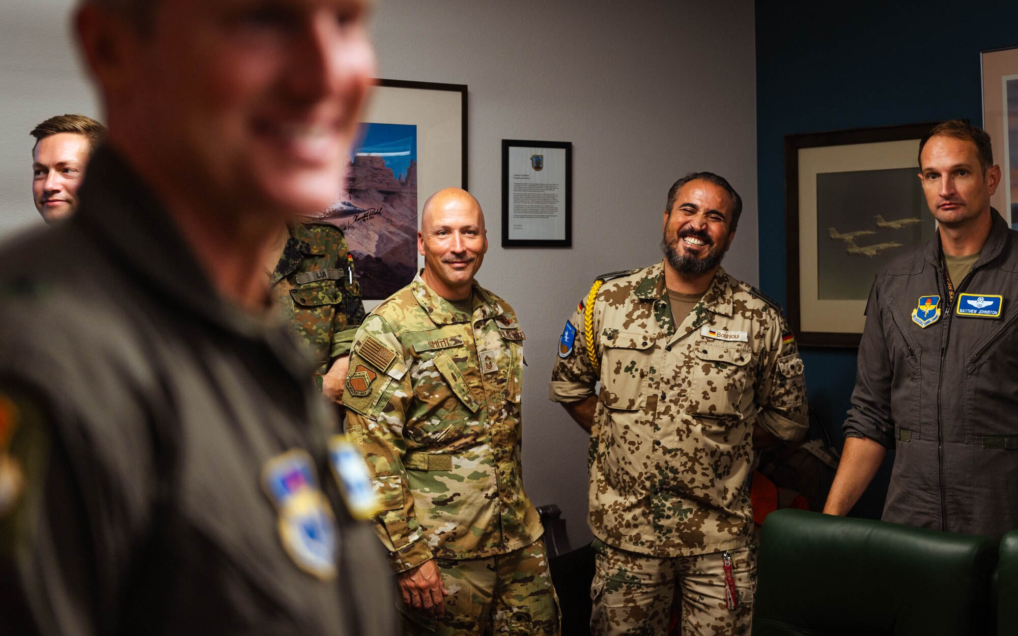 Members of the U.S. and German Air Force look to Brig. Gen. Jason Rueschhoff (right), 56th Fighter Wing commander following the signing of a decree of honor between the Airmen of the 310th Fighter Squadron and the 2nd Flying Squadron of the Tactical Air Wing 33.