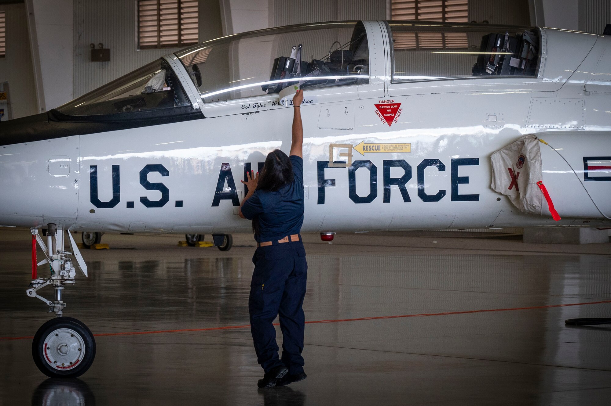 U.S. Air Force Mary Zuniga, 47th Maintenance Directorate dedicated crew chief, reveals Col. Tyler Ellison’s name on the 47th Flying Training Wing (FTW) flagship during the 47th FTW change of command ceremony at Laughlin Air Force Base, Texas, June 26, 2024. Ellison accepted the role as the 47th FTW commander from former commander Col. Kevin Davidson. (U.S. Air Force photo by Senior Airman Kailee Reynolds)