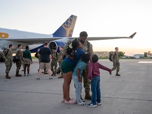 A U.S. Airman assigned to the 5th Bomb Wing reunites with family after returning from Bomber Task Force (BTF) 24-3 at Minot Air Force Base, North Dakota, June 26, 2024. BTF missions demonstrate the credibility U.S. our forces to address a global security environment that is more diverse and uncertain than at any other time in recent history. (U.S. Air Force photo by Airman 1st Class Luis Gomez)