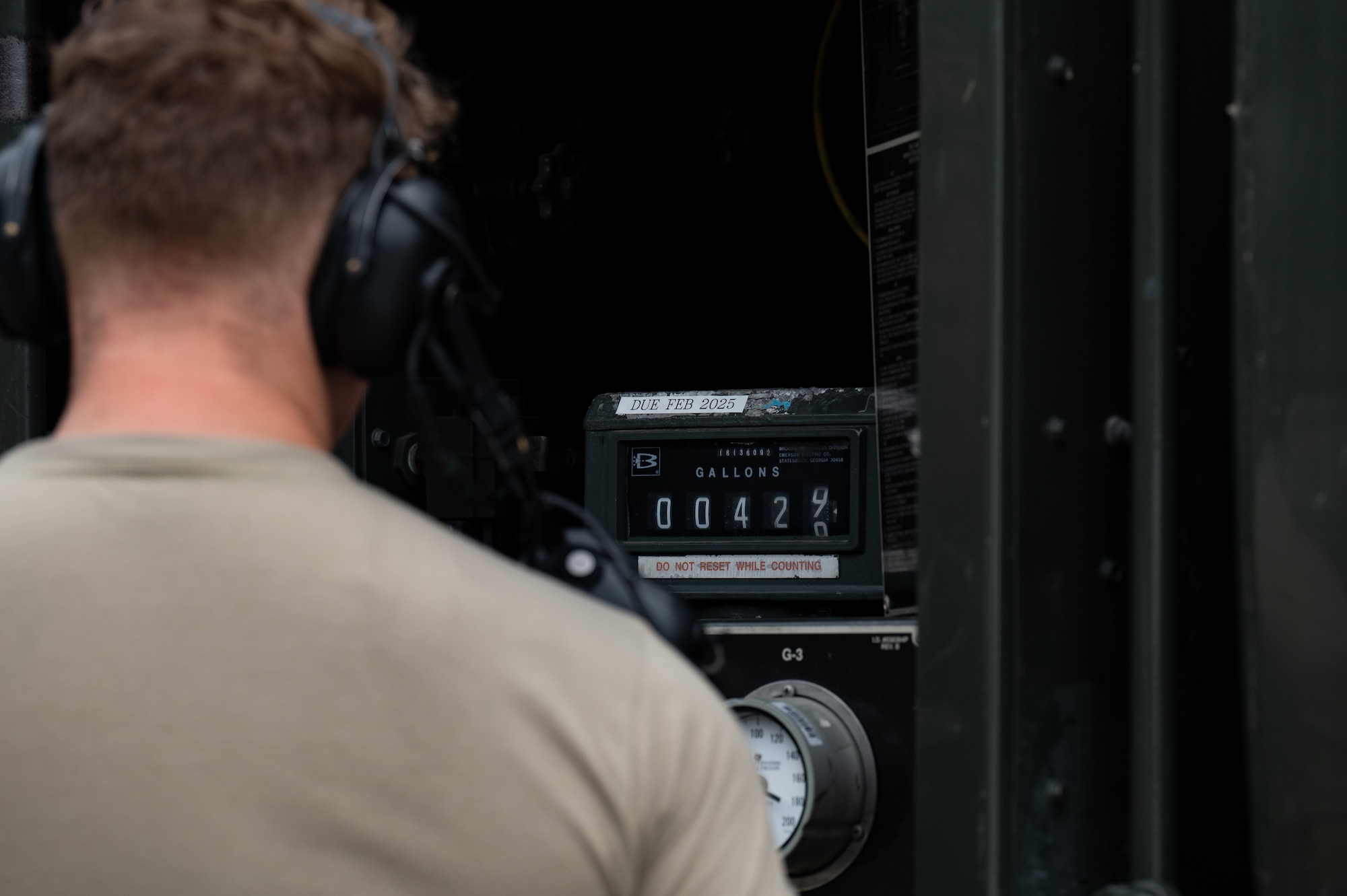 person looking at a fuel meter
