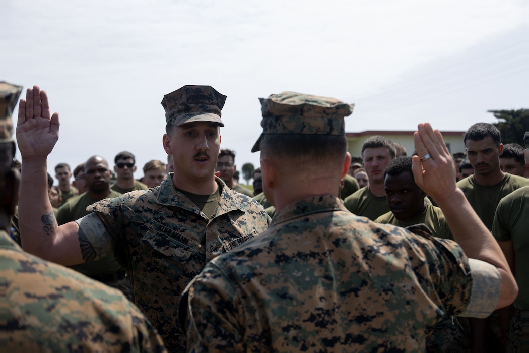 U.S. Marine Corps SSgt. Brenden Kuhlmann, left, reaffirms his oath of enlistment during a promotion ceremony on Camp Hansen, Okinawa, Japan, April 11, 2024. Kuhlmann was meritoriously promoted to staff sergeant for superior performance in his occupational specialty and as recognition of his ability to assume positions of greater authority and responsibility. Kuhlmann, a native of Alaska, is an artillery electronics technician with 12th Marine Littoral Regiment, 3d Marine Division. (U.S. Marine Corps photo by Sgt. Alyssa Chuluda)