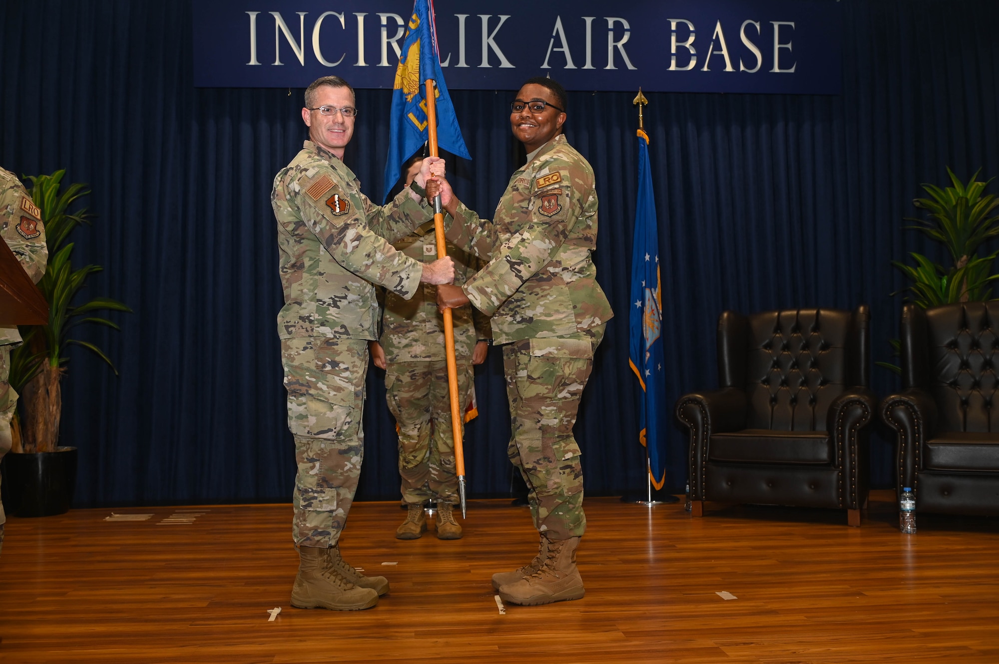 U.S. Air Force Col. Steven Skipper, 39th Mission Support Group commander, hands the 39th Logistics Readiness Squadron guidon to Maj. Damiqua Champion during the 39th LRS assumption of command ceremony at Incirlik Air Base, Türkiye, June 27, 2024. The change of command and assumption of command ceremonies are long-standing military traditions that represents the formal transfer of responsibility from one officer to another. (U.S. Air Force photo by Staff Sgt Alexandria Lee)