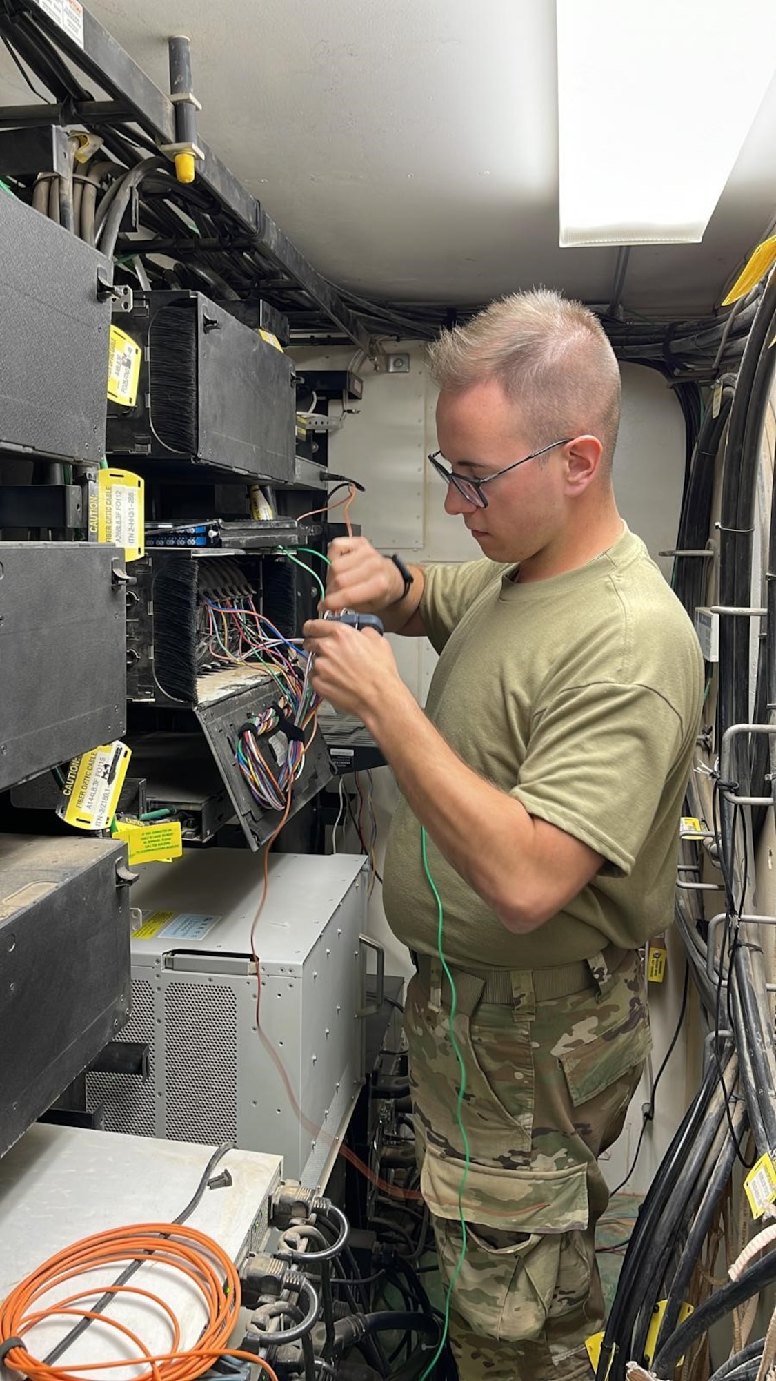 An Airman assigned to the 1st Expeditionary Theater Support Group splices fiber optic cable at an undisclosed location within the U.S. Central Command area of responsibility, June 12, 2024. The ETSG have executed operations in 12 countries and at 22 sites throughout the AOR. (U.S. Air Force Courtesy photo)