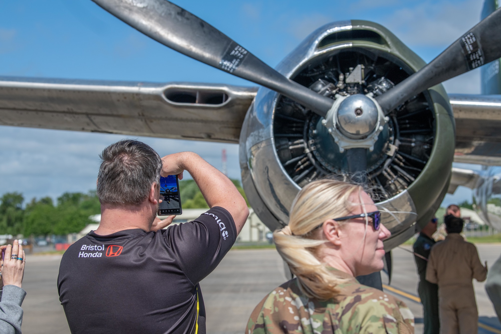 A man takes a photo of an A-26C engine