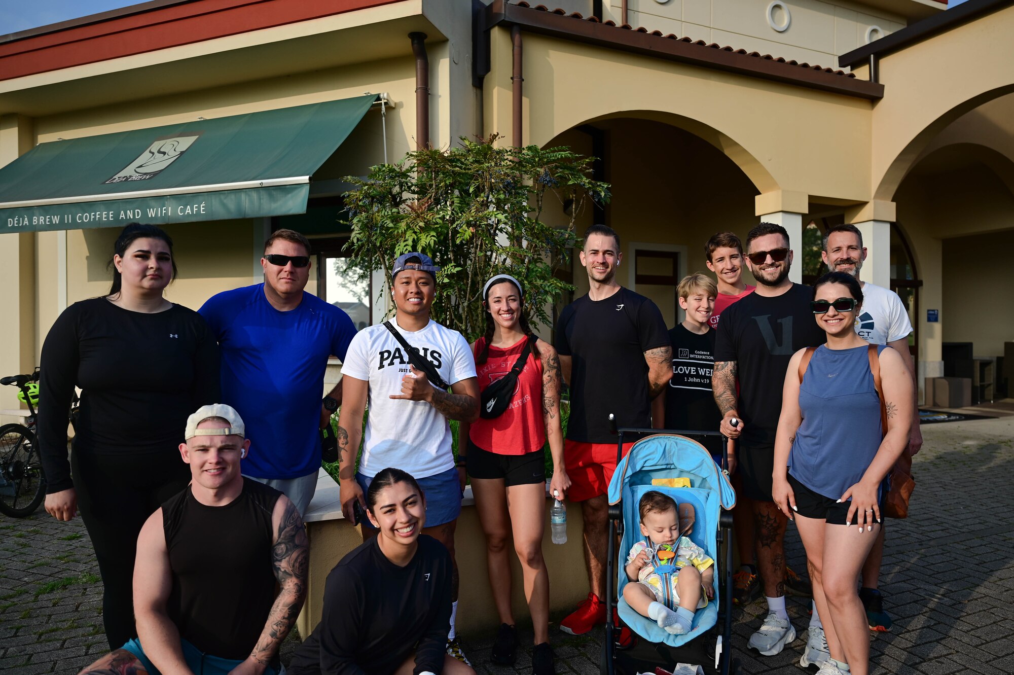 people pose for photo outside