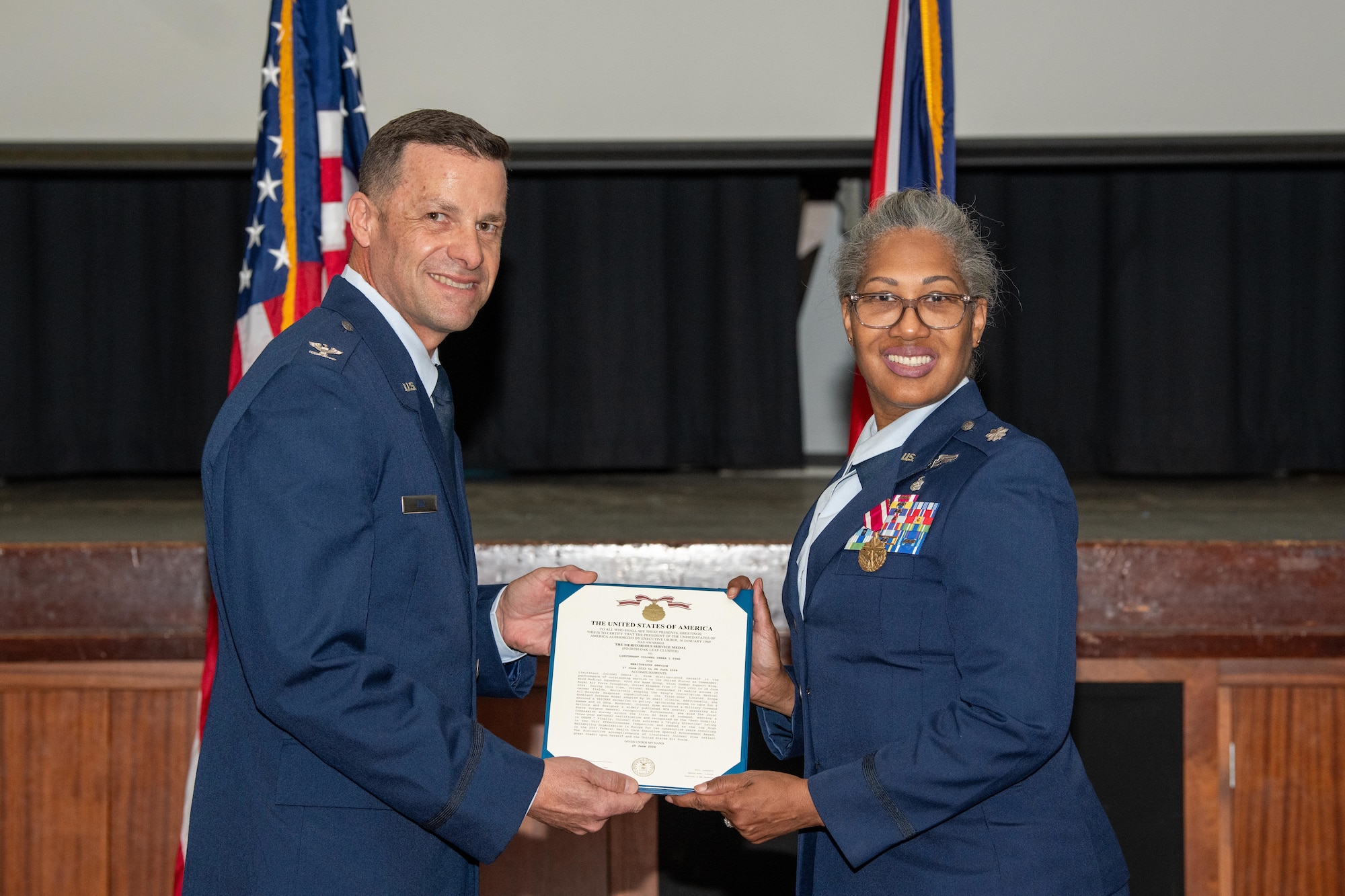Airmen smile while posing for a photo