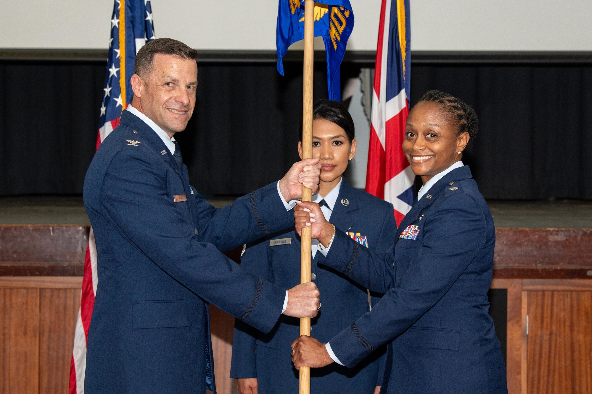 Airmen hold a guidon