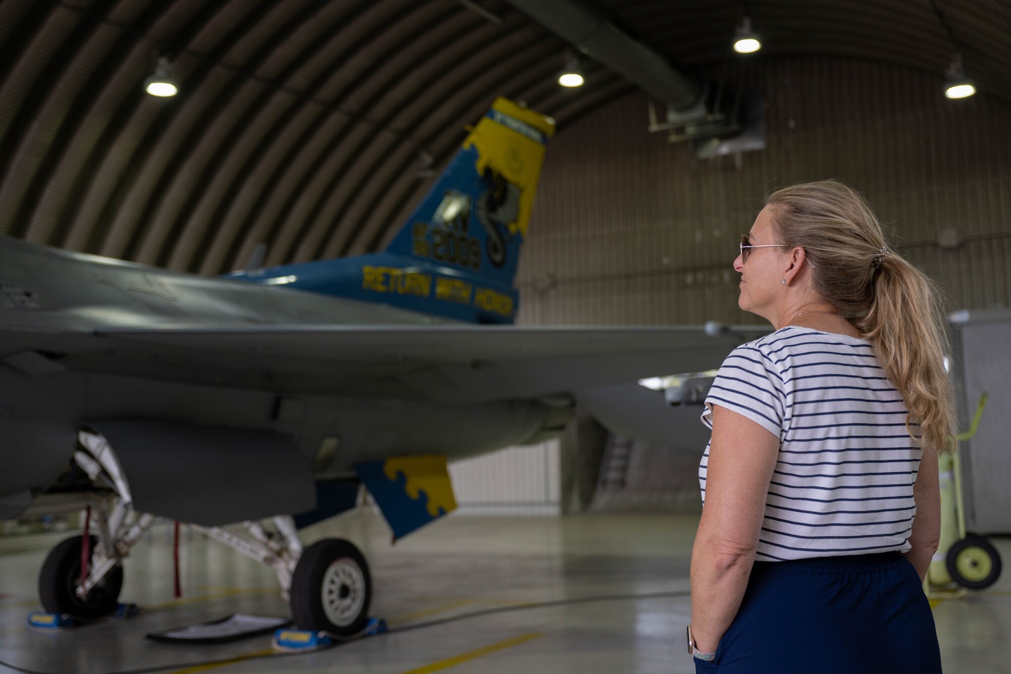 Civic leader Linda Morales admires an F-16 Fighting Falcon.