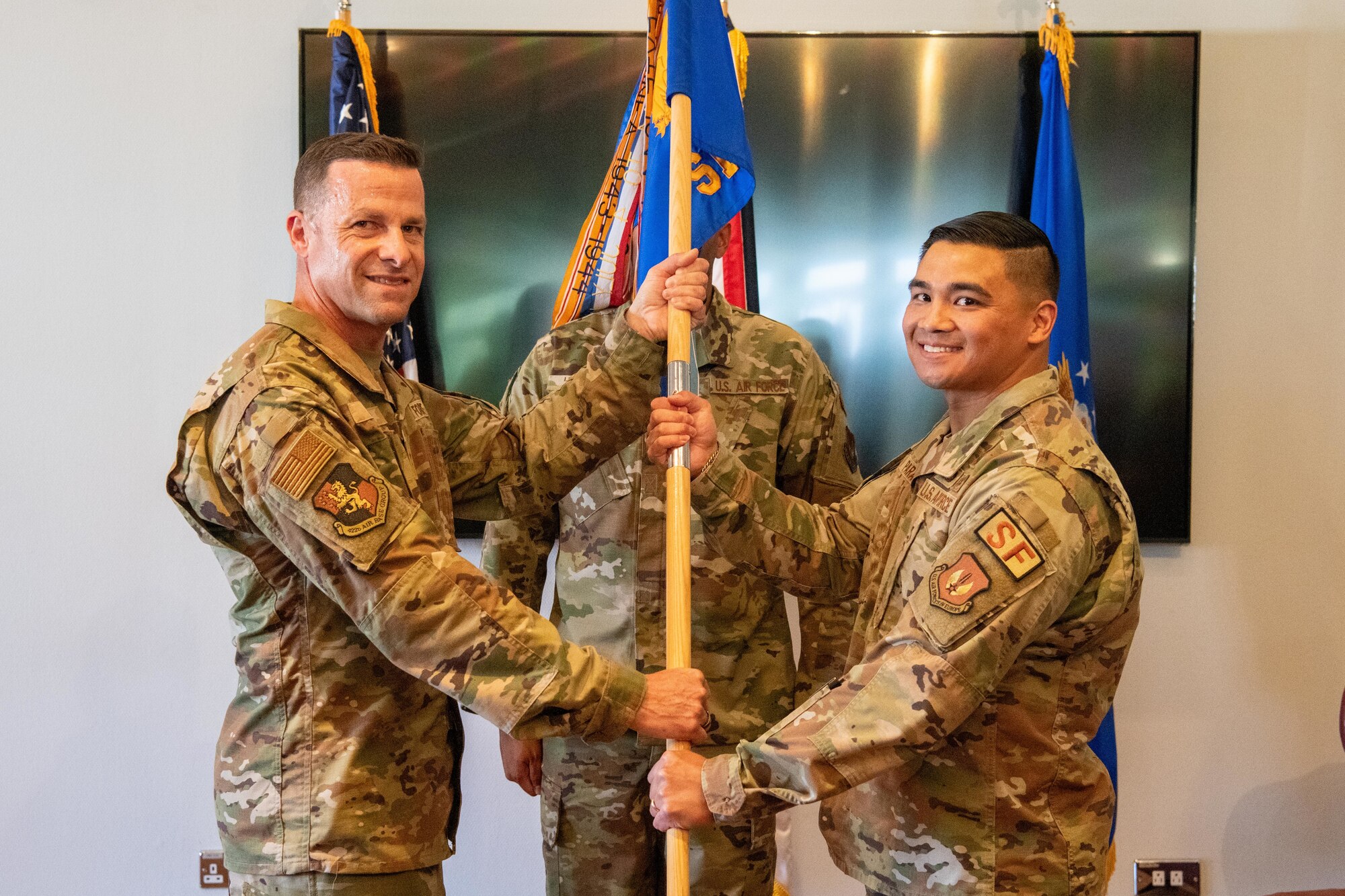 Airmen hold a guidon