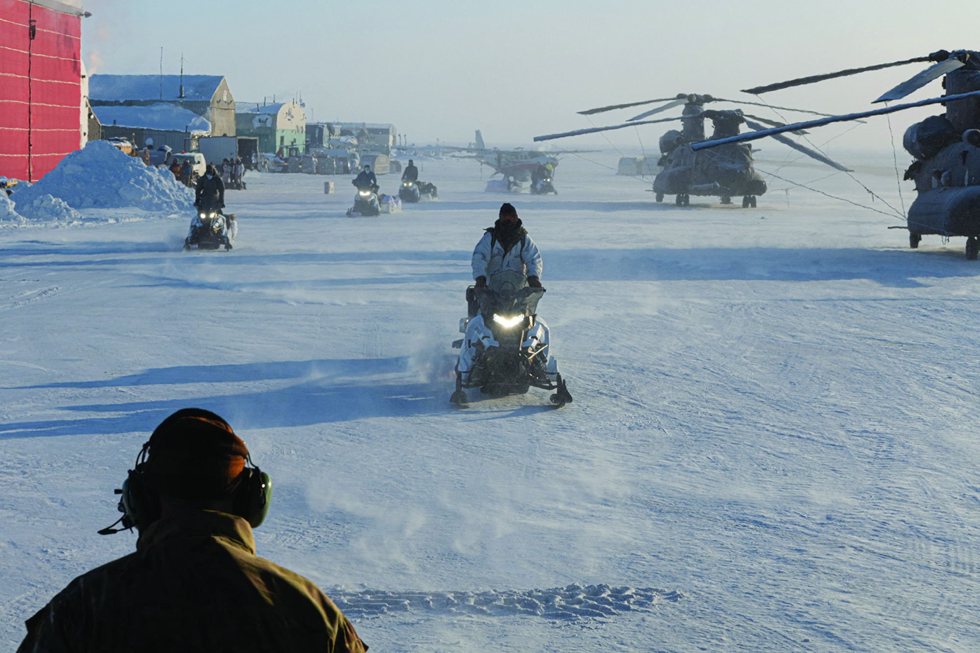 US Army Soldiers assigned to the 10th and 19th Special Forces Groups load equipment and snowmobiles into a MC-130J Commando II during Arctic Edge 24 in Utqiagvik, Alaska, 8 March 2024.