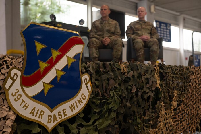 U.S. Air Force Cols. Kevin Lord, 39th Air Base Wing outgoing commander, and Brandon McBrayer, 39th ABW incoming commander, sit during the change of command ceremony.