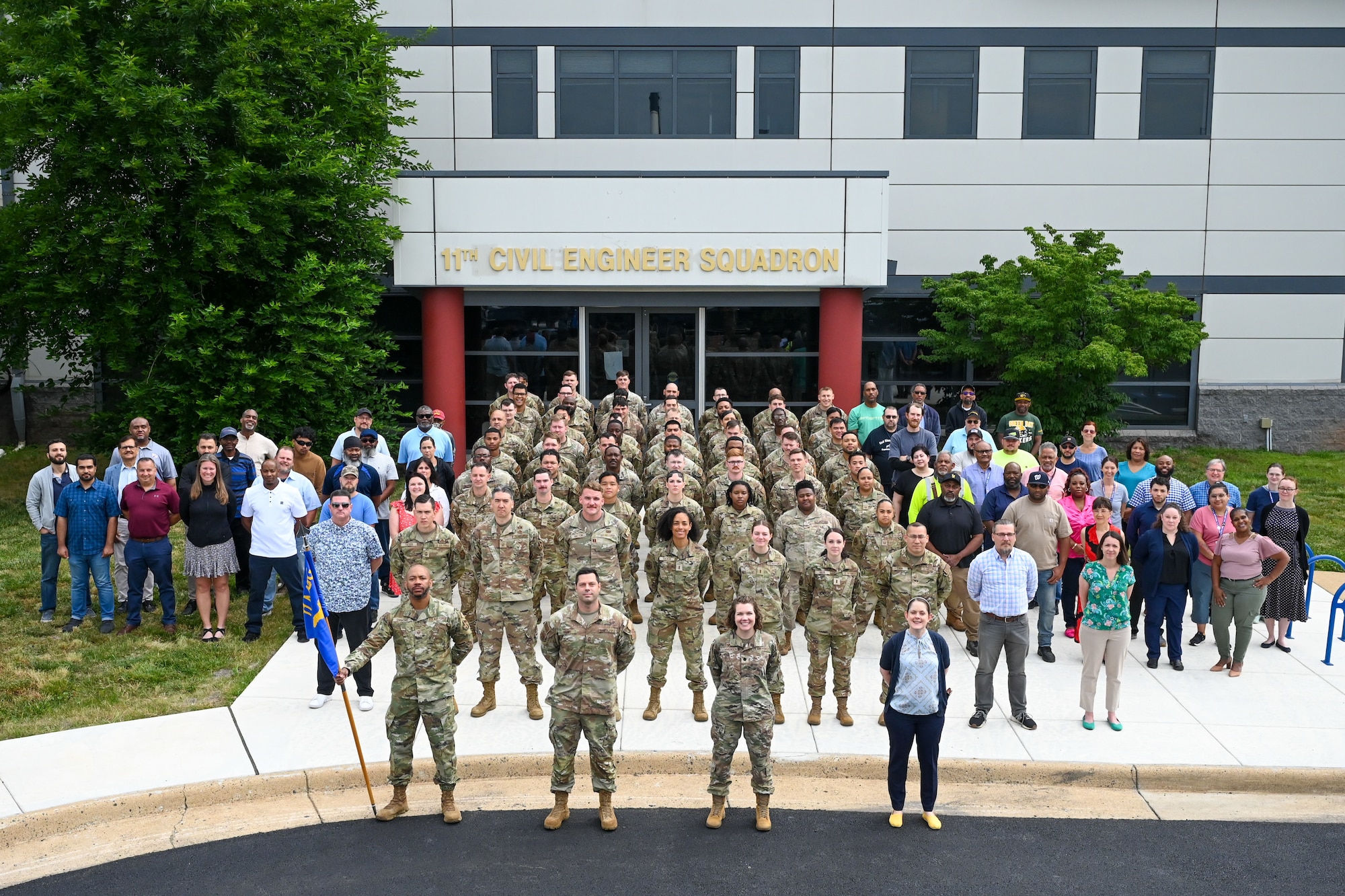 Members of the 11th Civil Engineer Squadron pose for a photo in front of the 11th CES building at Joint Base Anacostia-Bolling, Washington, D.C., June 11, 2024. More than 100 members participated in the squadron photo. (U.S. Air Force photo by Airman Shanel Toussaint)