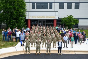 Members of the 11th Civil Engineer Squadron pose for a photo in front of the 11th CES building at Joint Base Anacostia-Bolling, Washington, D.C., June 11, 2024. More than 100 members participated in the squadron photo. (U.S. Air Force photo by Airman Shanel Toussaint)