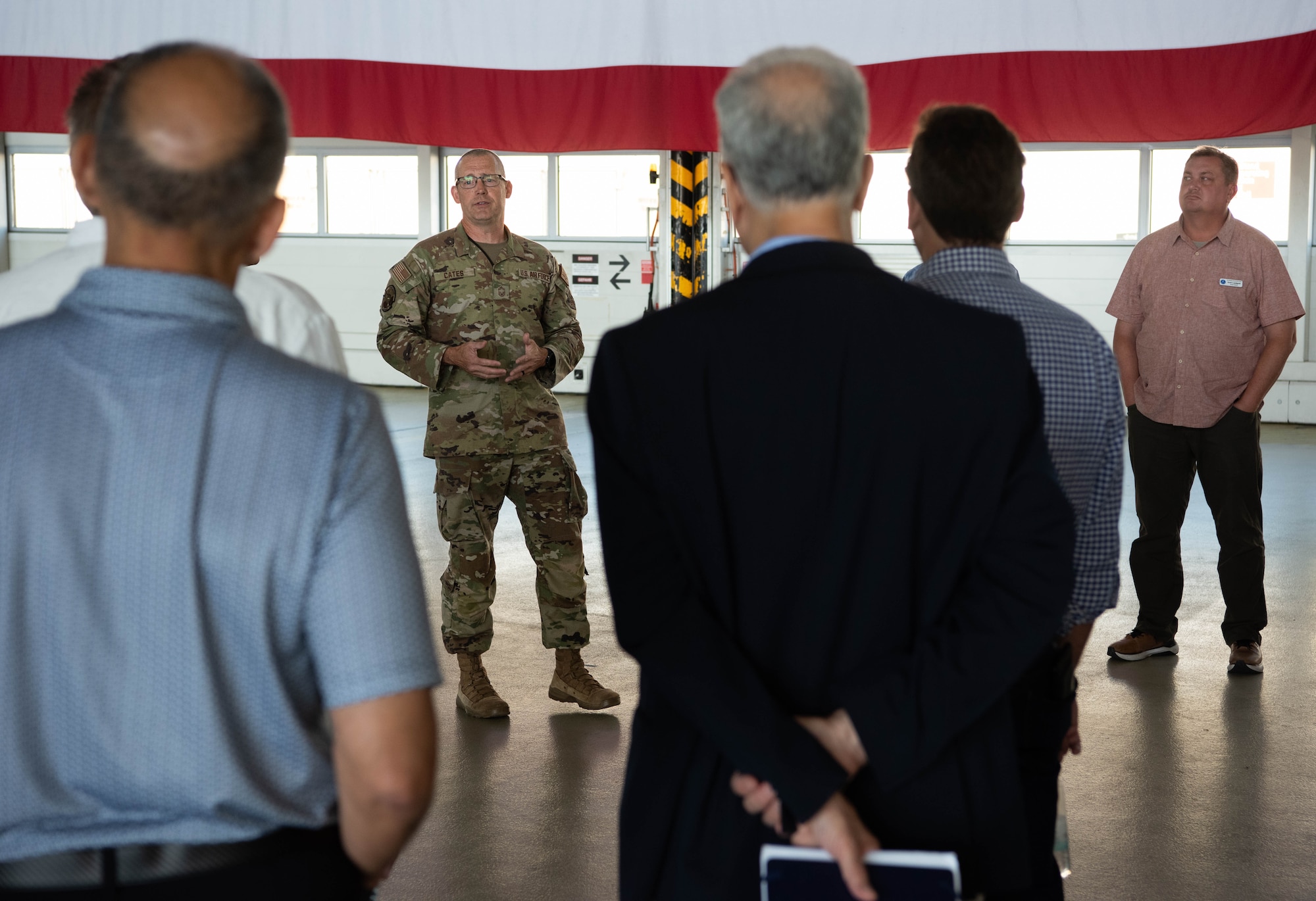 U.S. Air Force Chief Master Sgt. William Cates, 721st Aircraft Maintenance Squadron senior enlisted leader, gives a 721st AMXS mission brief to members of the Air and Space Forces civic leader group during an immersion at Ramstein Air Base, Germany, June 25, 2024. Civic leaders are unpaid advisors, key communicators and advocates for Department of the Air Force issues. The civic leader group engaged in a multi-day tour across U.S. Air Forces in Europe – Air Forces Africa bases to receive valuable familiarization and education on USAFE-AFAFRICA missions, future initiatives, and command priorities. (U.S. Air Force photo by Senior Airman Jared Lovett)