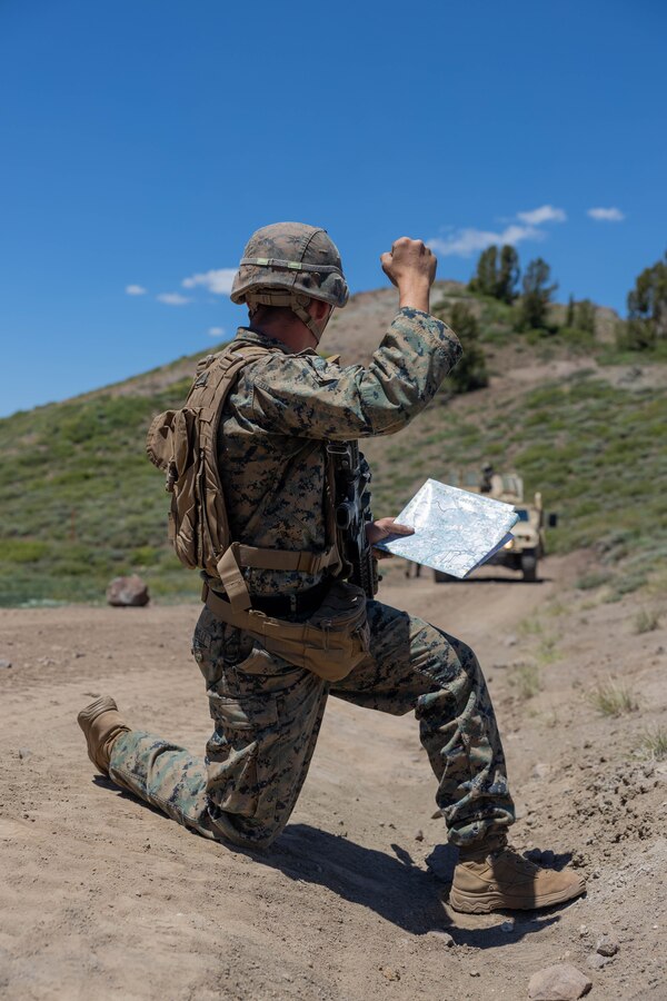 A U.S. Marine with 1st Battalion, 25th Marine Regiment, 4th Marine Division signals his convoy to halt during the culminating event of Mountain Training Exercise 4-24 at Marine Corps Mountain Warfare Training Center, Bridgeport, California, June 23, 2024. Marines undergo a 72-hour evaluation testing them in tactics, techniques and procedures for mountain warfare. (U.S. Marine Corps photo by Staff Sgt. Jestin Costa)