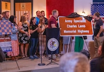 Illinois Army National Guard Soldiers who served in the 1544th Transportation Company’s 2004 deployment to Iraq unveil the road sign designating Highway 40 through Casey as the Army Specialist Charles Lamb Memorial Highway at a ceremony June 26 at Casey Veterans of Foreign Wars Post 5762 in Casey. Lamb, who grew up in Casey, was killed Sept. 5, 2004 during a mortar attack in Baghdad, Iraq.