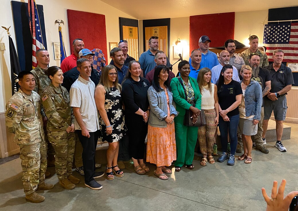 Current and former Soldiers serving in the 1544th Transportation Company, based in Paris, gather for a group photo during a ceremony June 26 redesignating Highway 40 through Casey as the Army Specialist Charles Lamb Memorial Highway.