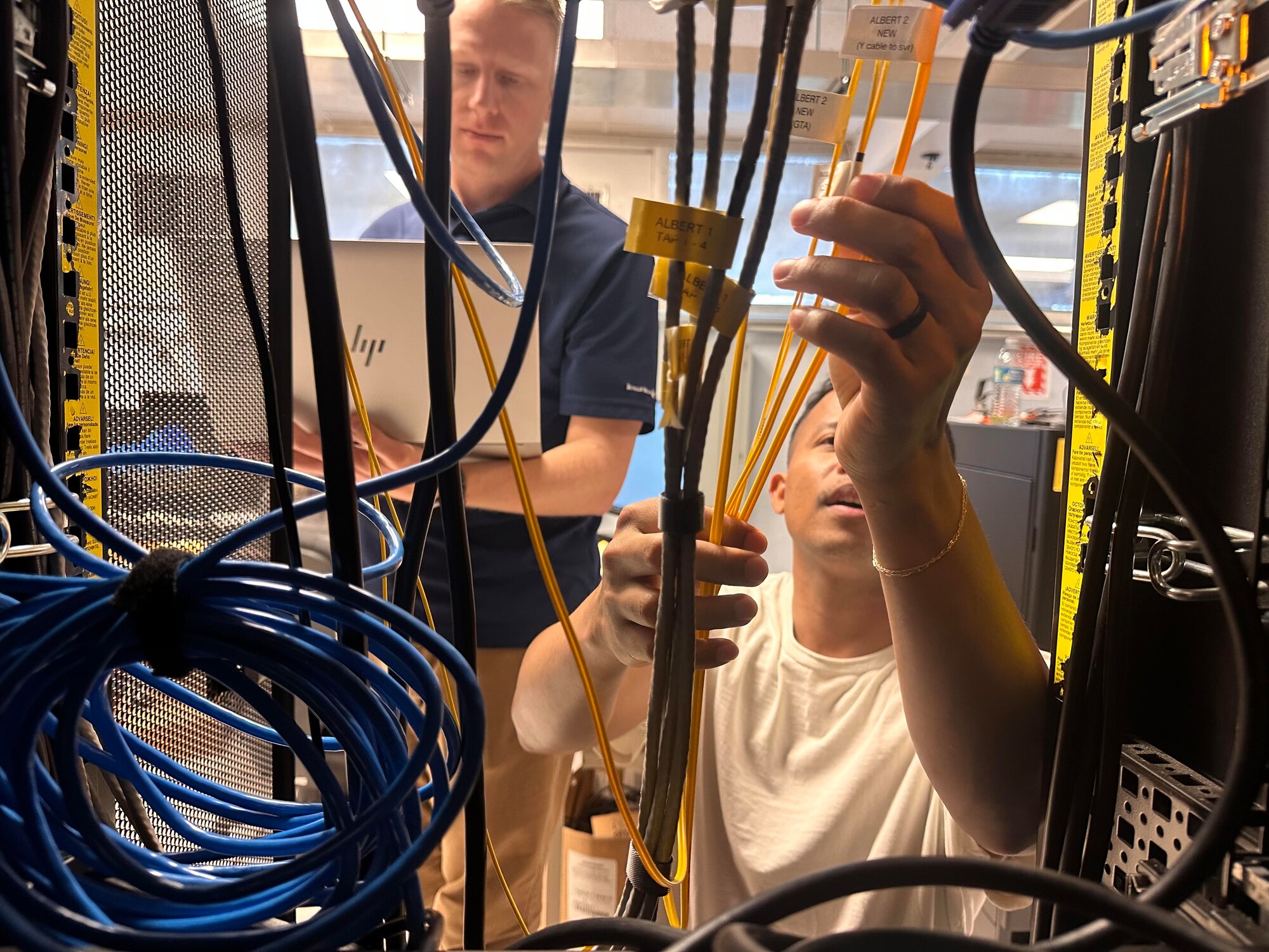 Technical Sergeant Colton Dalley and Senior Airman Paul Martin, 14th Test Squadron, Shriever Space Force Base, Colorado, work on Guam’s cybersecurity infrastructure as part of the Innovative Readiness Training (IRT) cybersecurity event on Guam June 4 to 14. Cybersecurity isn’t the only service Air Force Reserve Command’s IRT team provides -- they also perform medical, civil engineering and aerial spray services for U.S. communities in need. (U.S. Air Force courtesy photo)