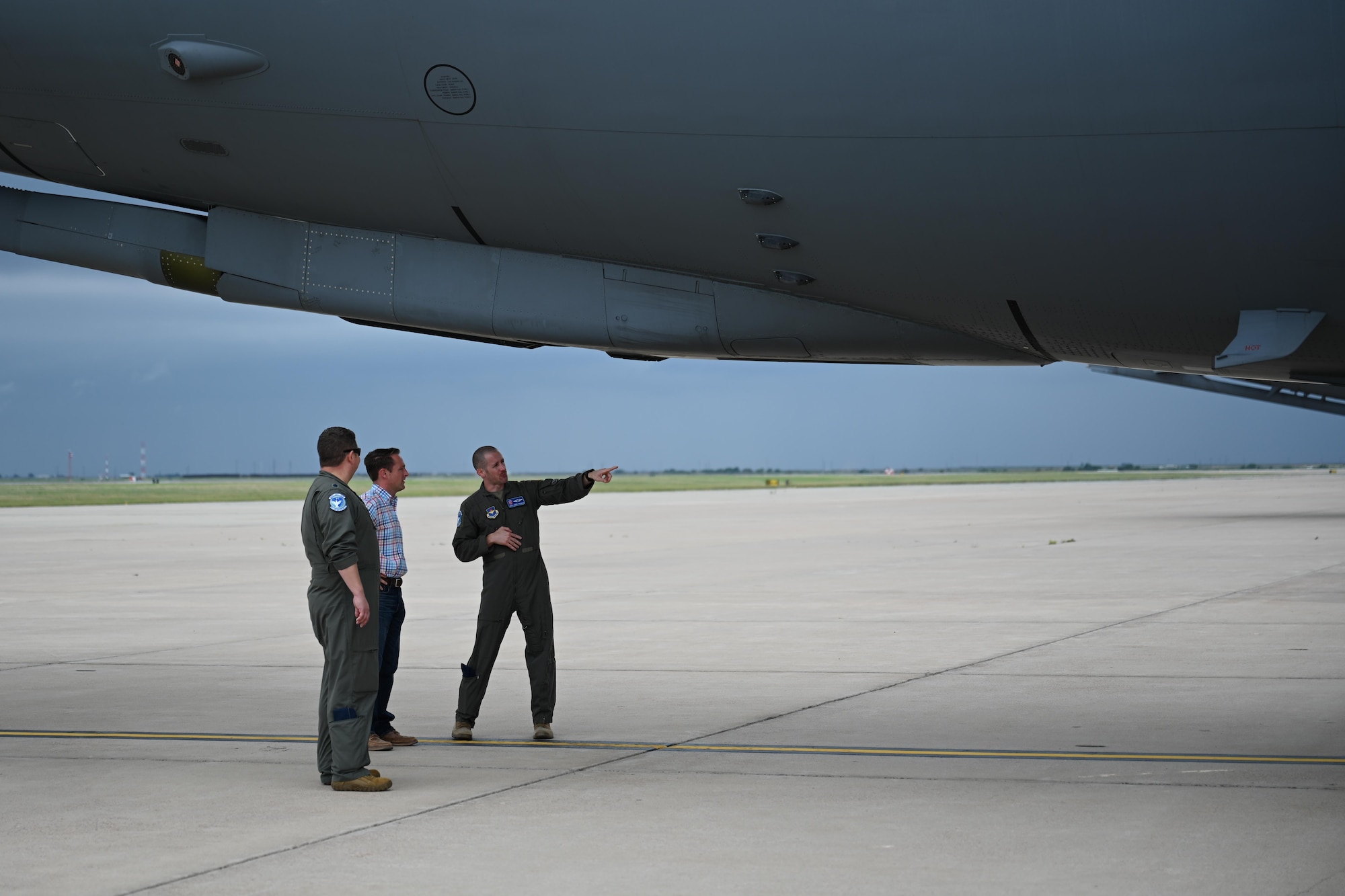 U.S. Air Force Senior Master Sgt. Joseph Vondohlen, 56th Air Refueling Squadron (ARS) senior enlisted leader, right, shows Carson Vinyard, 56th ARS honorary commander, middle, how the boom of a KC-46 Pegasus aircraft operates, on the flightline of Altus Air Force Base, Oklahoma, June 11, 2024. Nearly all internal fuel can be pumped through the boom of the aircraft. (U.S. Air Force photo by Airman 1st Class Jonah G. Bliss)
