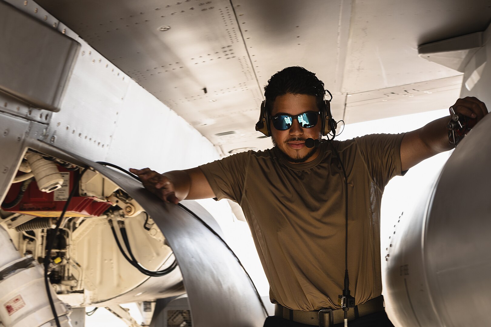 U.S. Air Force Senior Airman Jean Zambrano, 177th Aircraft Maintenance Squadron crew chief, poses for a photograph, while preparing an F-16 Fighting Falcon fighter jet from the 177th Fighter Wing, New Jersey Air National Guard, for takeoff during a launch at Joint Base Pearl Harbor-Hickam, Hawaii, June 5, 2024. The enlisted Airmen of the 177FW played a vital role in keeping the unit’s aircraft operational during Sentry Aloha 24-2.