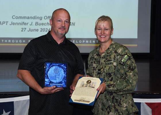 JOINT BASE SAN ANTONIO-FORT SAM HOUSTON – (June 27, 2024) – Darrel Mercer, a management analyst assigned to Naval Medical Research Unit (NAMRU) San Antonio, was recognized by Commanding Officer Capt. Jennifer Buechel (Nurse Corps) as the Fiscal Year 2024 “Support Staff” Civilian of the Half Year (First Half) during an All Hands meeting held at the Military and Family Readiness Center.  NAMRU San Antonio is one of the leading research and development laboratories for the U.S. Navy under the Department of Defense and is one of eight subordinate research commands in the global network of laboratories operating under the Naval Medical Research Center in Silver Spring, Md.  Its mission is to conduct gap driven combat casualty care, craniofacial, and directed energy research to improve survival, operational readiness, and safety of DOD personnel engaged in routine and expeditionary operations. (U.S. Navy photo by Burrell Parmer, NAMRU San Antonio Public Affairs/Released)