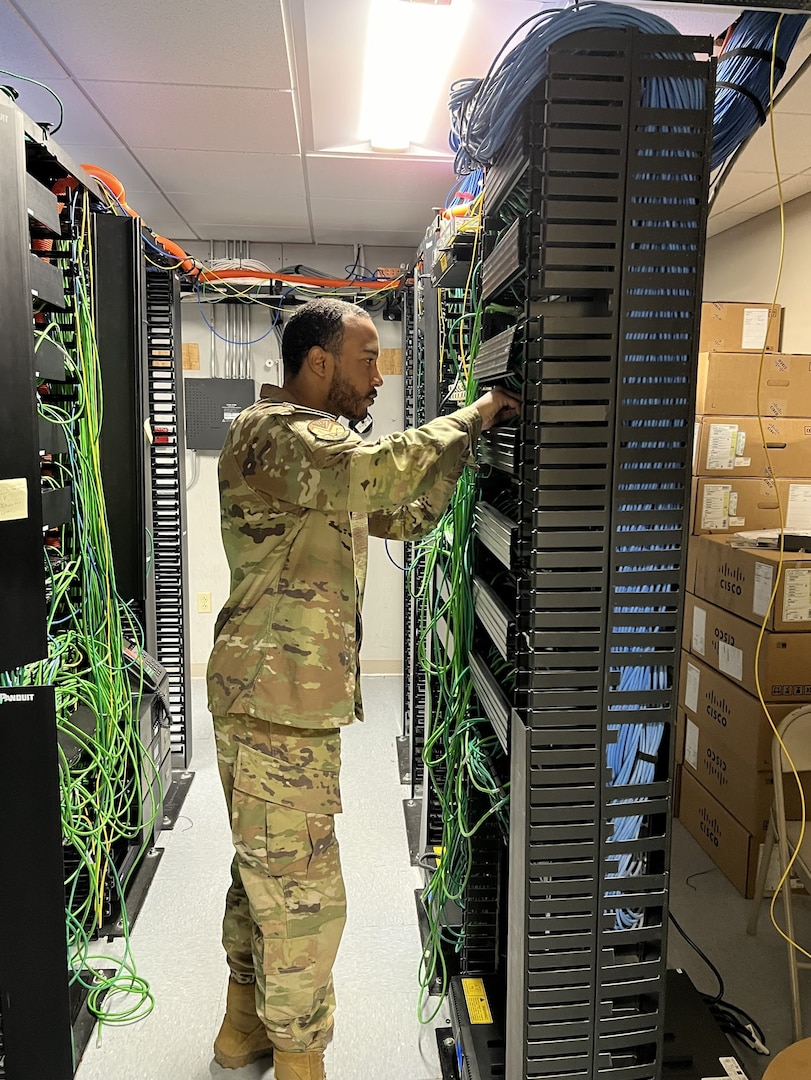 Staff Sgt. DeAnthony Norales of the 212th Engineering Installation Squadron, Otis Air National Guard Base, Mass., reroutes network cabling after upgrading the switches in the rack. Airmen peformed network infrastructure upgrades at Joint Base Langley-Eustis in May 2024.